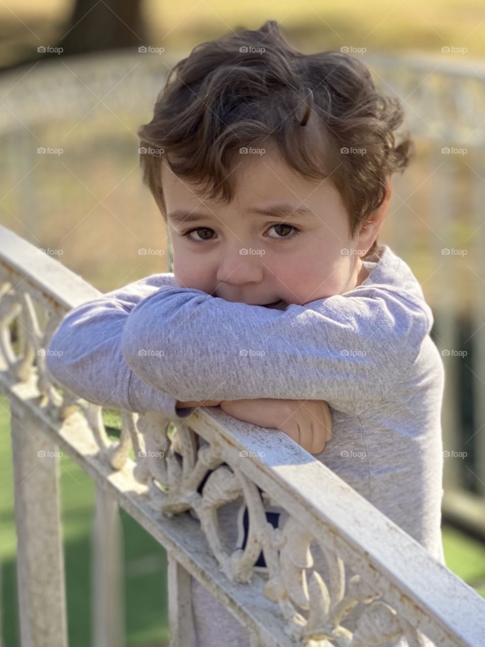 Pensive boy on bridge