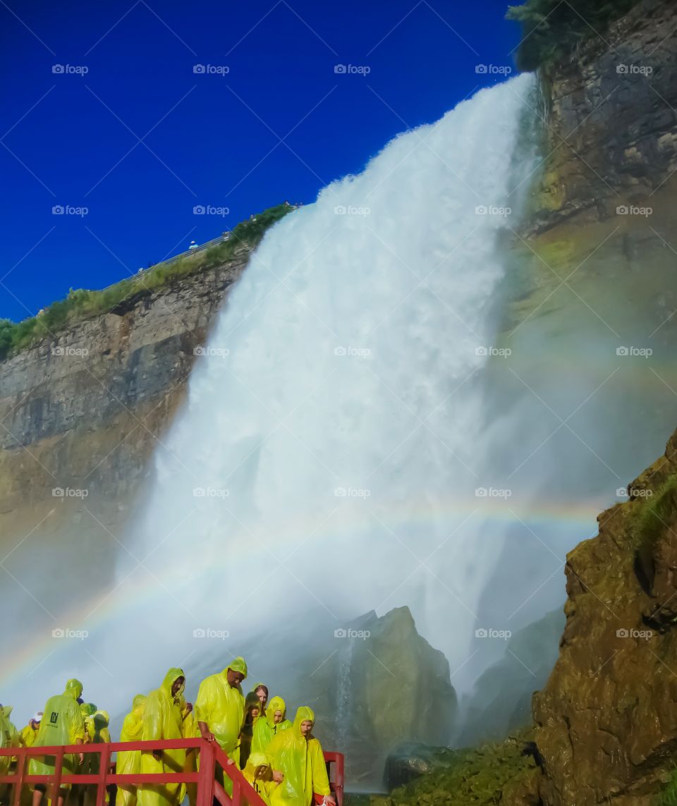 people and rainbow at Niagara falls NY