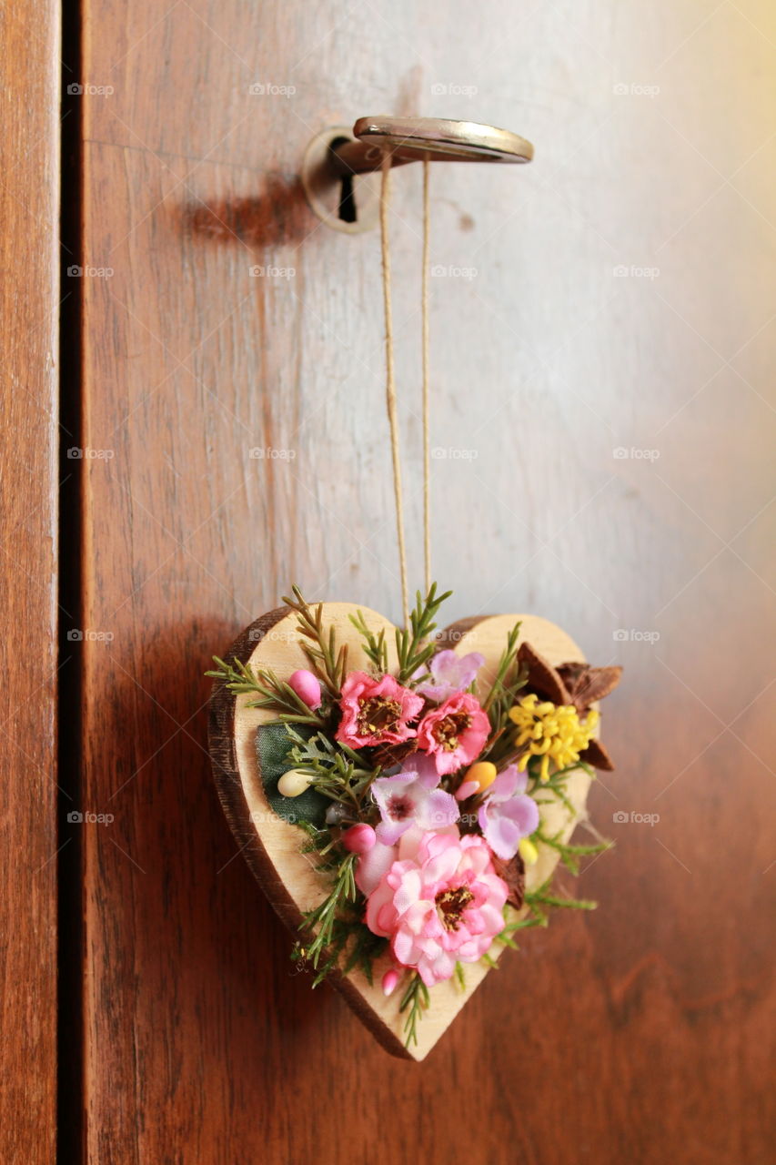 beautiful wooden heart with flowers decoration hanging on the closet key