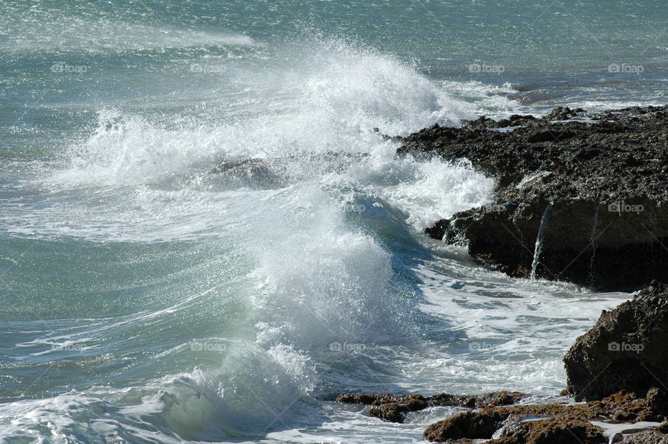 Wave splashing rock