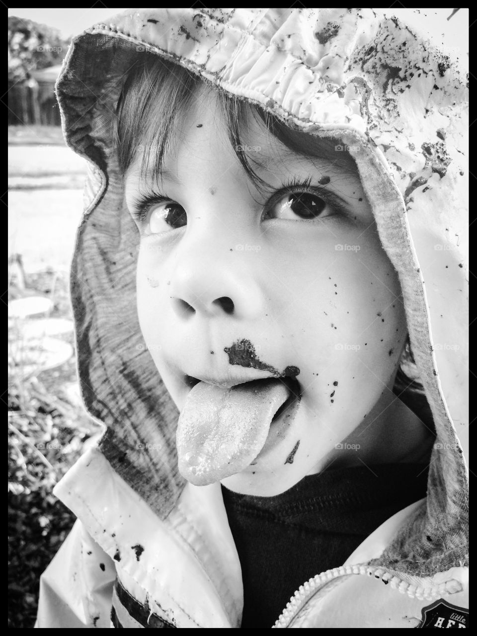 Muddy face. Boy with mud splattered on his face