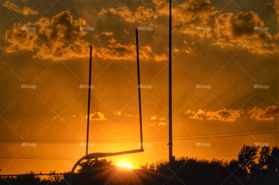 Sun rays under a football goal 