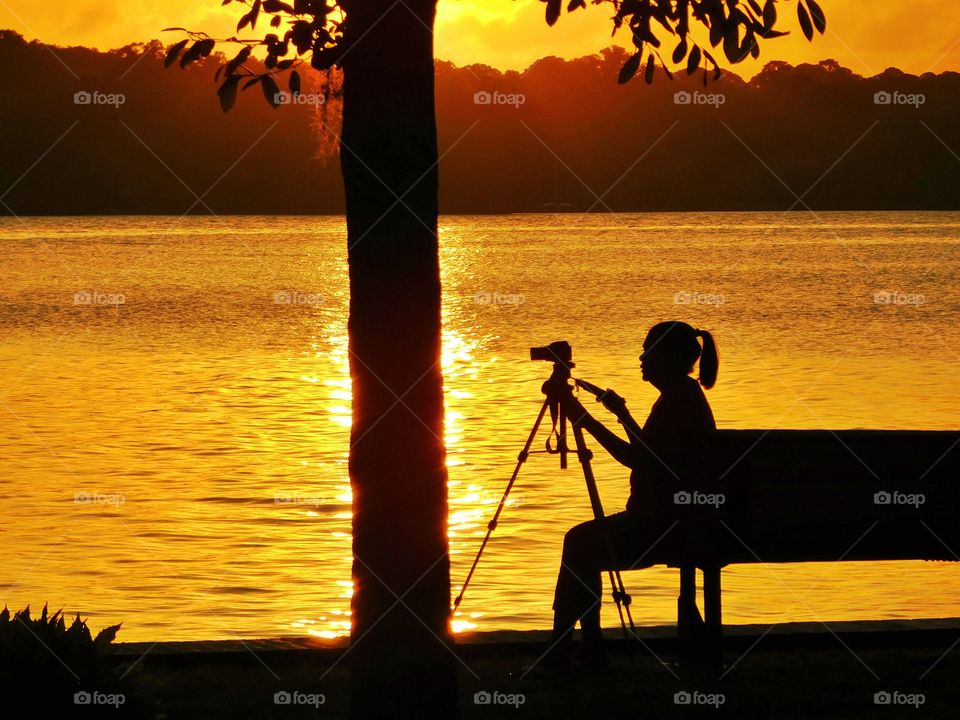 A woman being photographed, photographing a magnificent sunset over Choctawhatchee Bay!