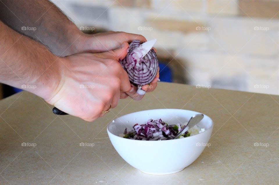 Close-up of person chopping onion