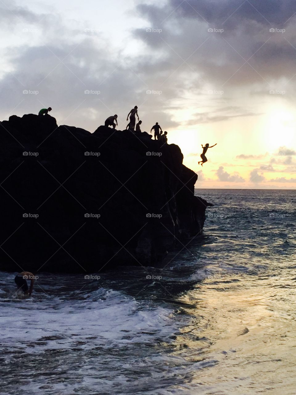 Jumping off Jump Rock Waimea Bay Hawaii 