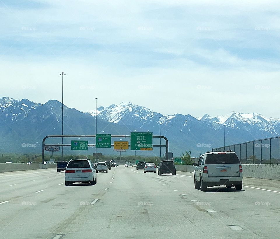 Driving into the mountains that surround Salt Lake City in Utah, USA. The highways are wide and the mountains are still snow capped in May.