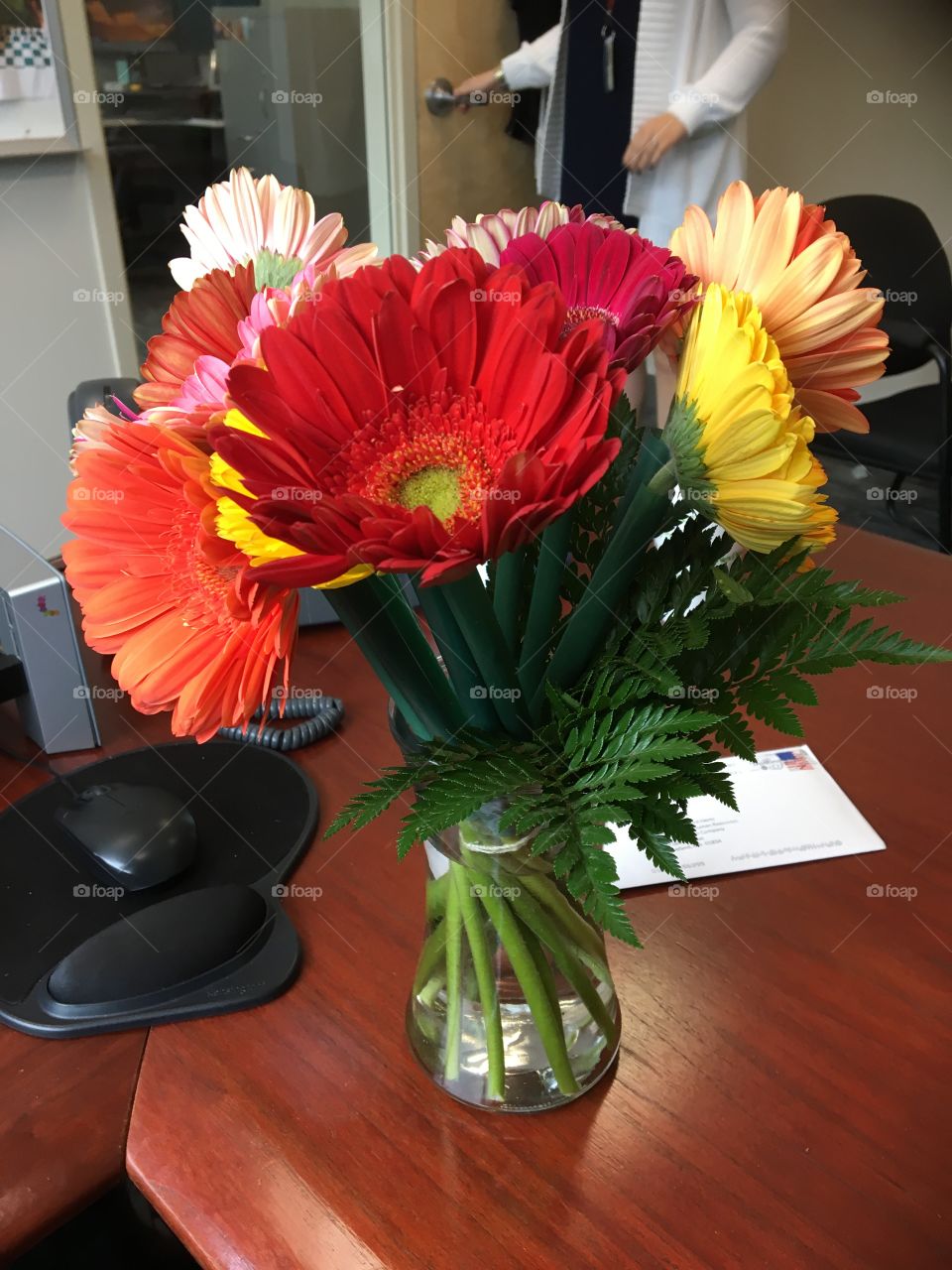 Office flower arrangement on desk. Brilliant colors
