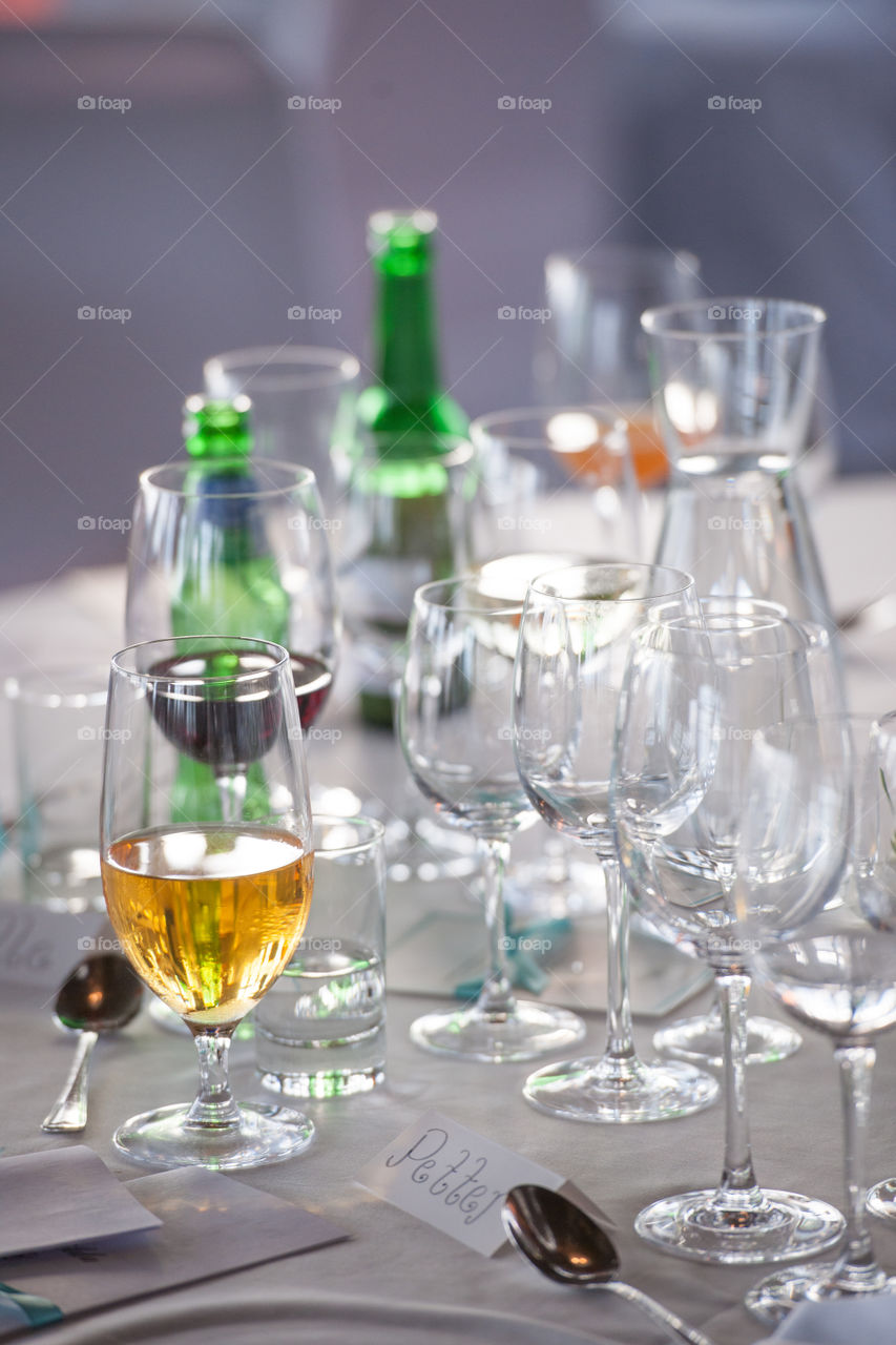 beer mugs and wine glasses on a dinner table at a party