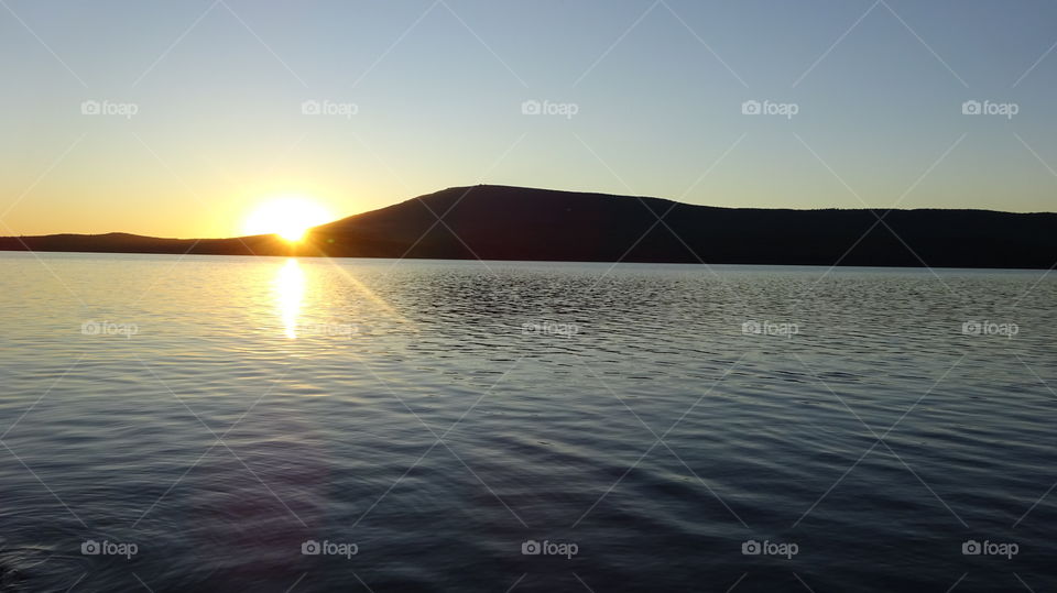 summer evening, sunset over the mountain Kachkanar in the Urals in Russia