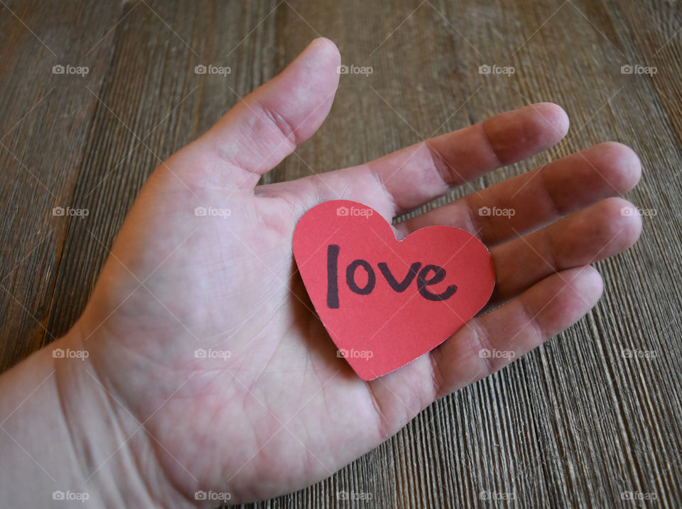 Hand holding heart shaped sentiment