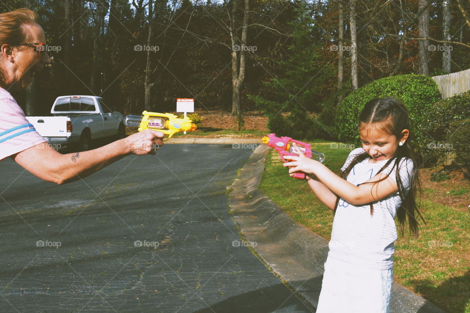 kid and nana shooting squirt guns