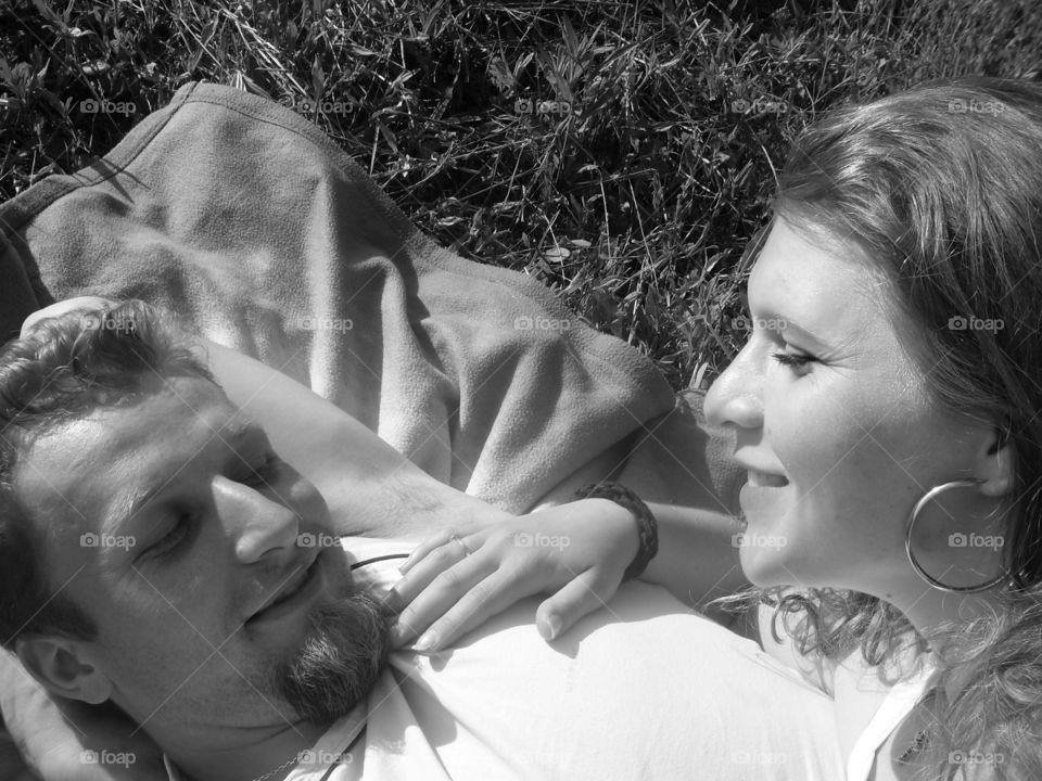 Smiling young woman lying on her husband