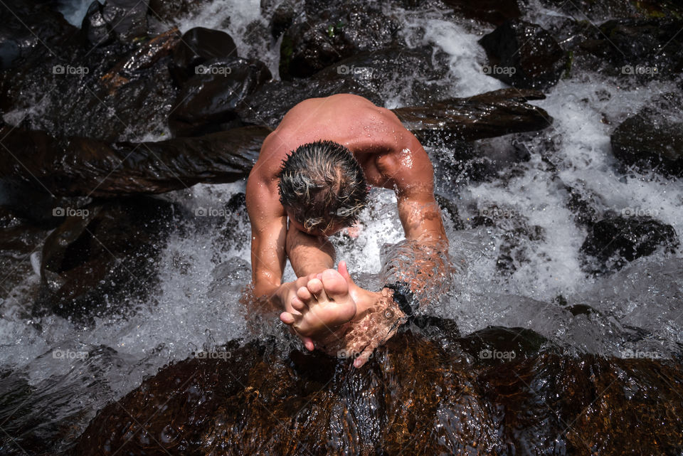 A day at the stream, a good friend doing a risky yoga pose on top of the slippery rock