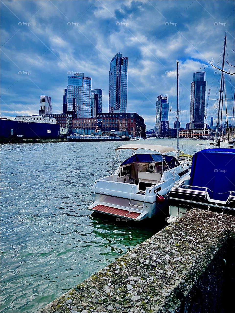 The waves are rippling up vivaciously along the shore of the “E River” at “Newtown Creek” by the “Pulaski Bridge”, the bridge connecting LIC, Queens and “Greenpoint”, Bklyn on this slightly overcast afternoon in January of 2023. Hypnotic Productions