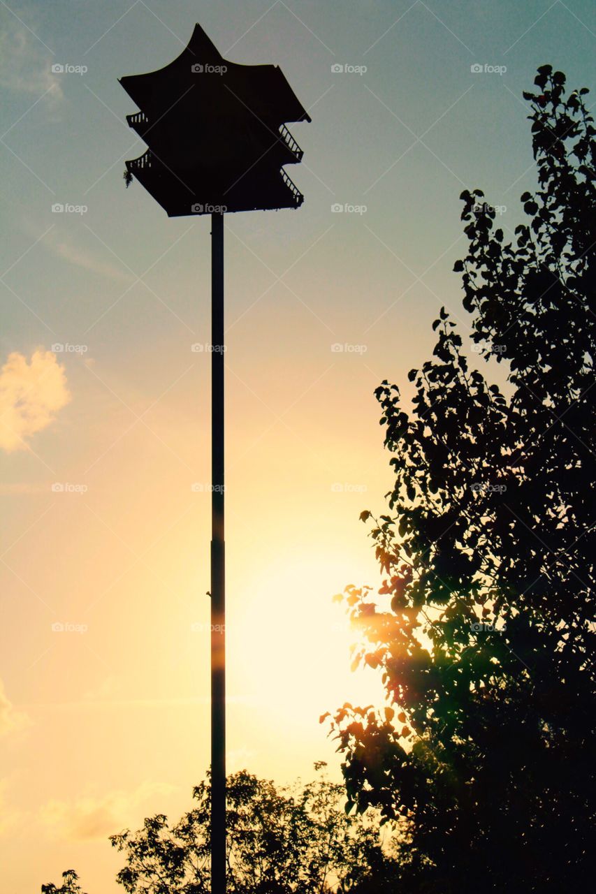 Birdhouse silhouette in the setting sun