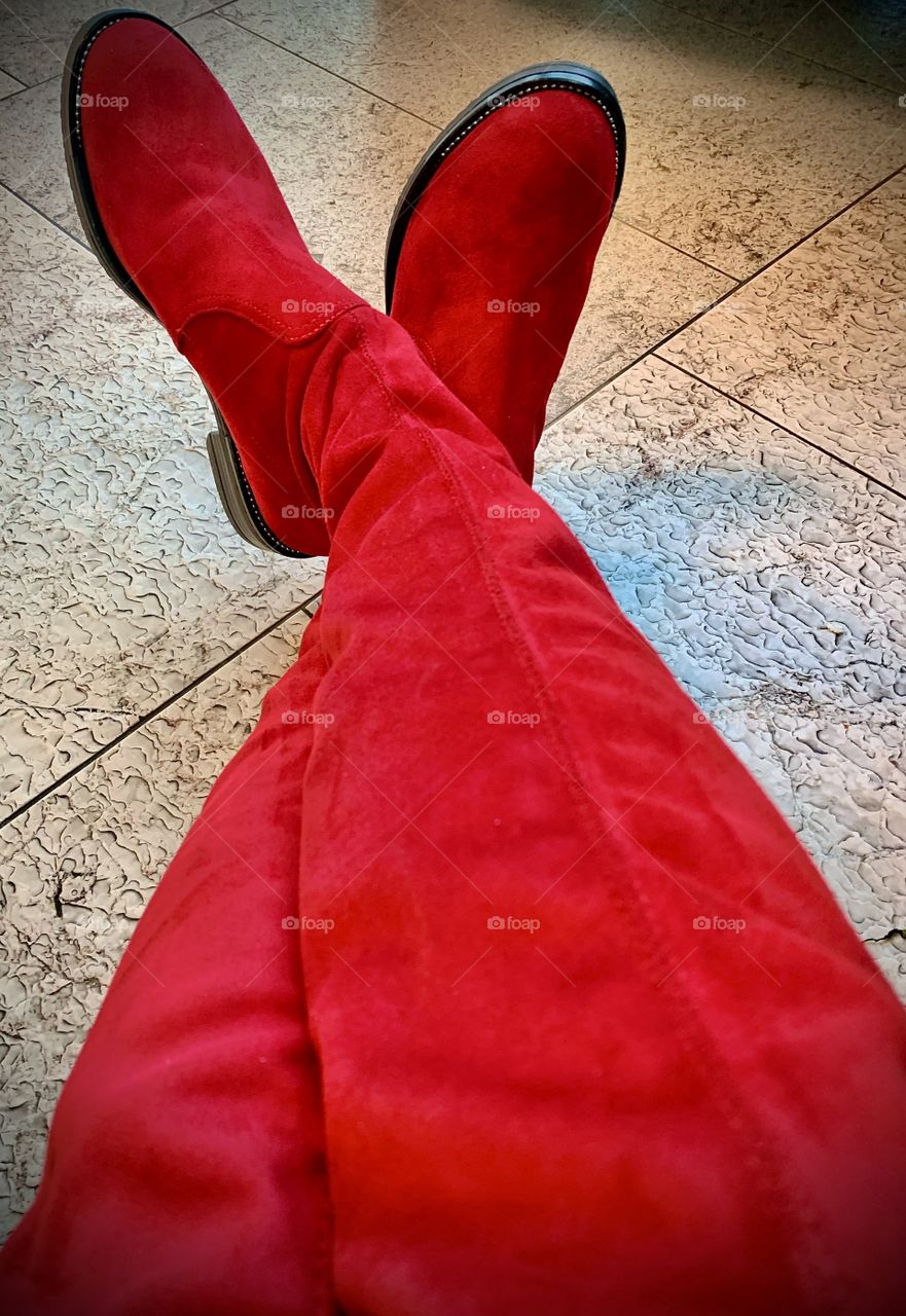 Red knee high suede boots are made for walking 