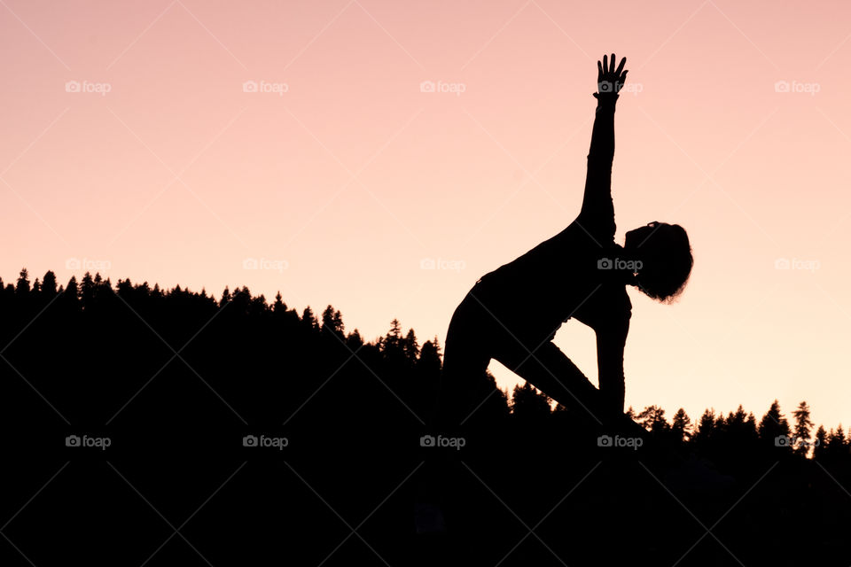 Beauty Yoga in twilight moment in front of land scape background