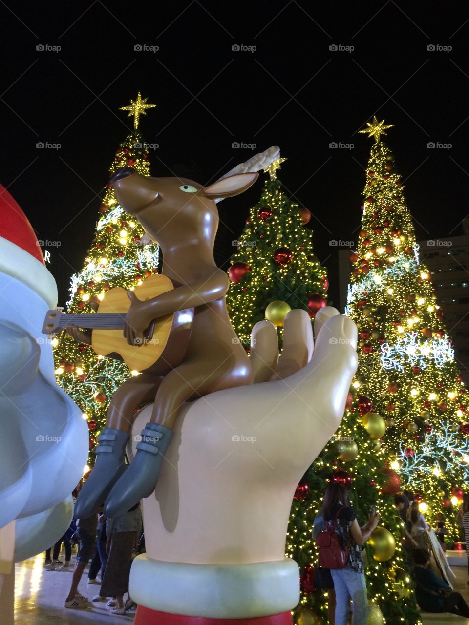 Deer playing guitar on hand