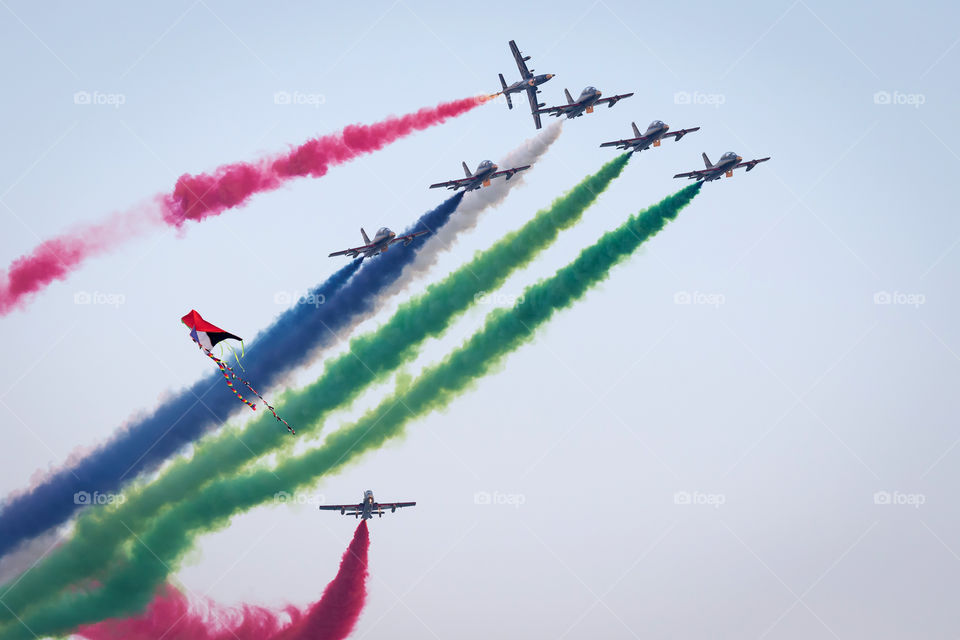 Aerobatic team flying high in the sky performing tricks with the smoke