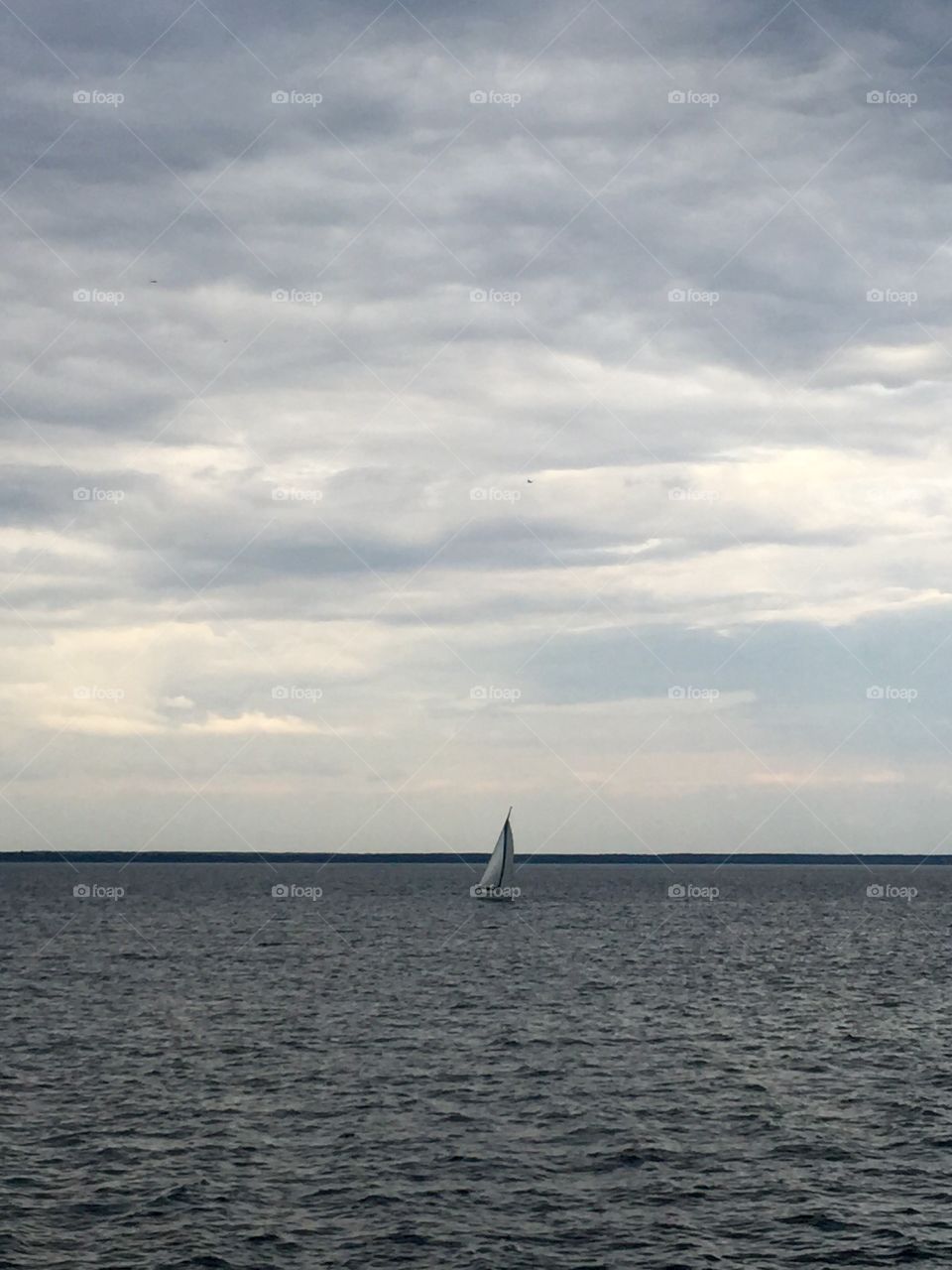 Lonely Sailing boat on the horizon