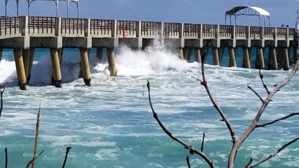 rough waves hitting the pier
