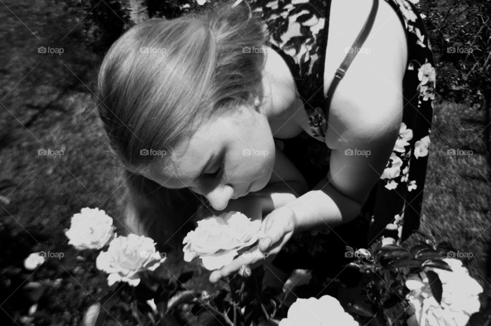 A girl smelling flowers