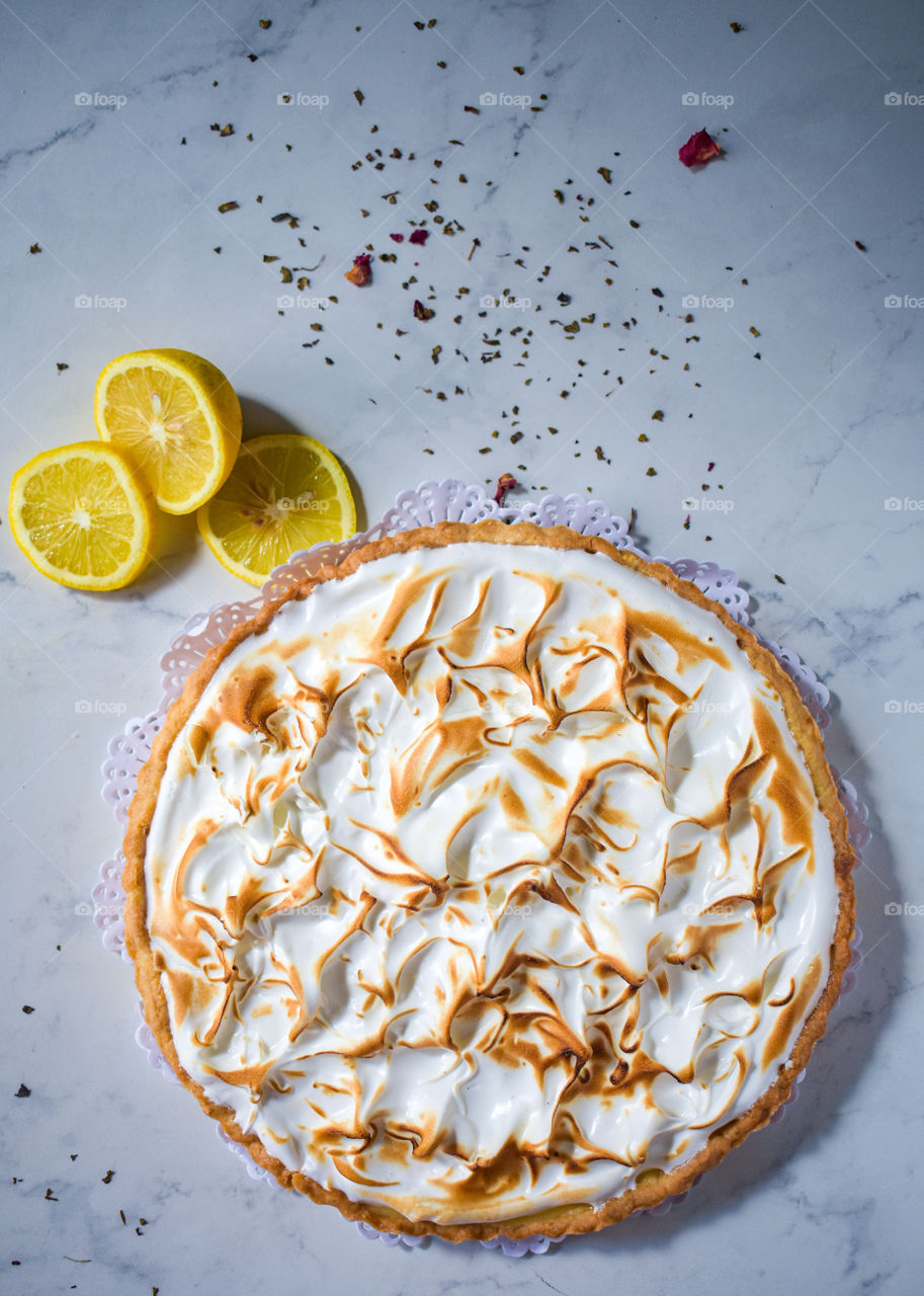 lemon pie with some lemon slices on Italian marble