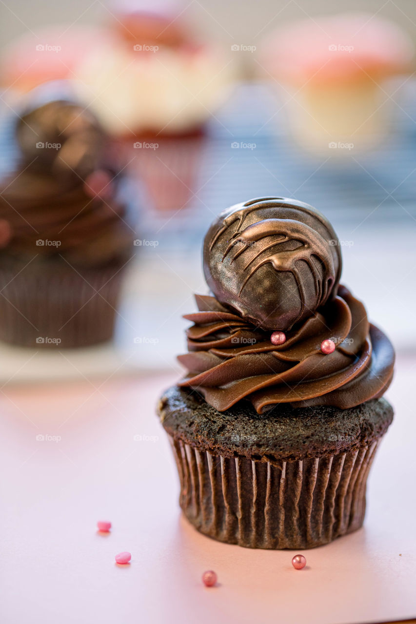 Chocolate covered strawberries on top of chocolate cupcake