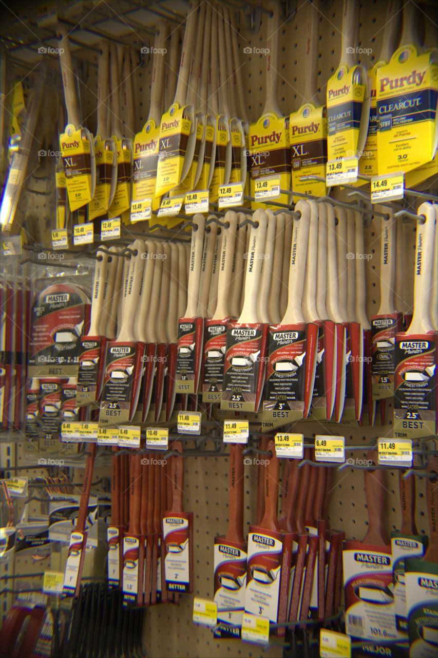 Paint Brushes Hanging on Peg Board at Hardware Store