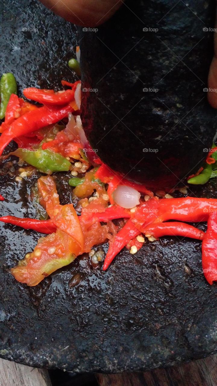 chili sauce is made from chili which is crushed so that the essence of chili comes out and other ingredients are added, such as salt and shrimp paste.