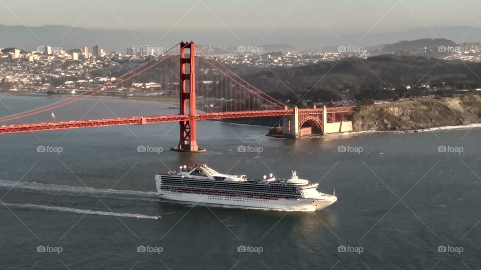 Golden Gate bridge, with a boat going underneath it