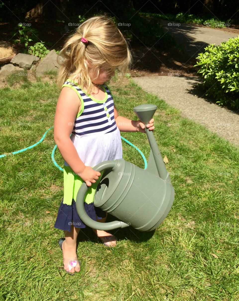 Little girl with water can