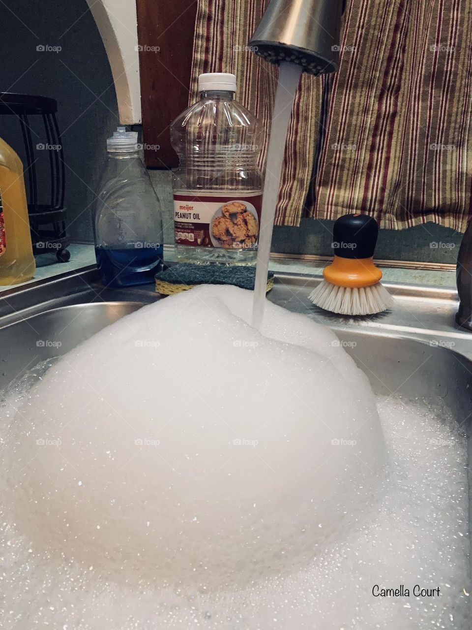 Bubbles in the sink prepping for dishes 