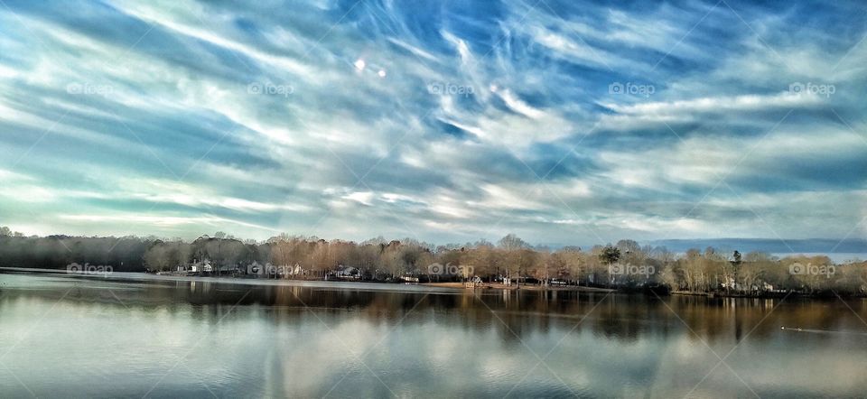 White wispy cloud reflections on water