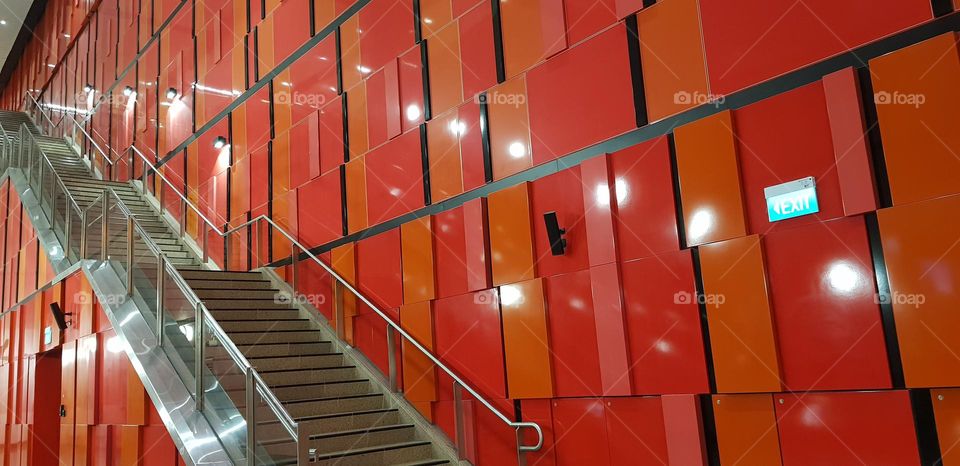 orange and red coloure rectangle shapes on wall near steps