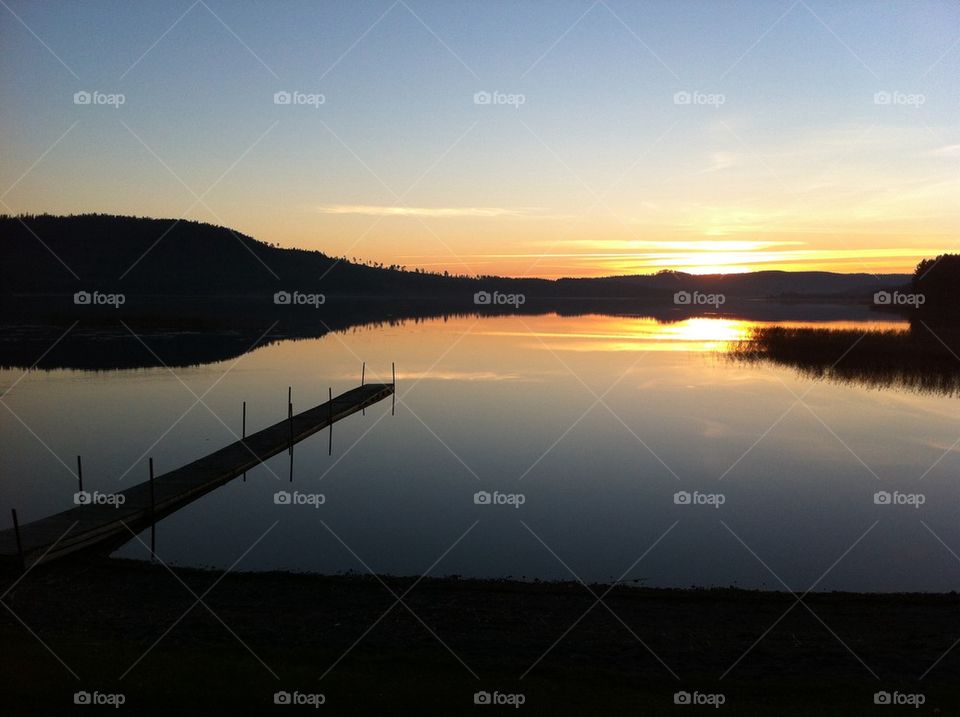 Pier over lake during sunset