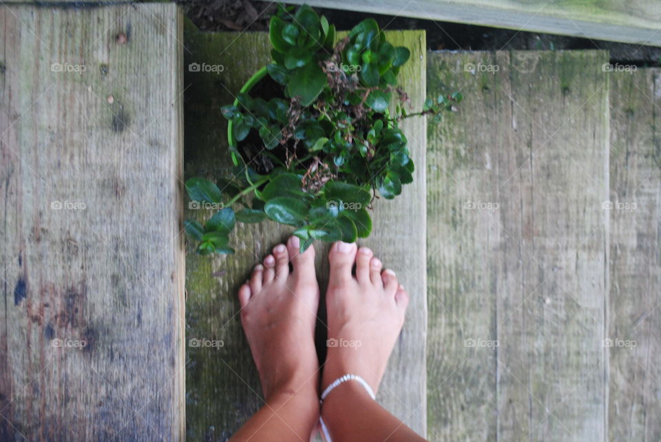 My feet at the stairs next to my flower