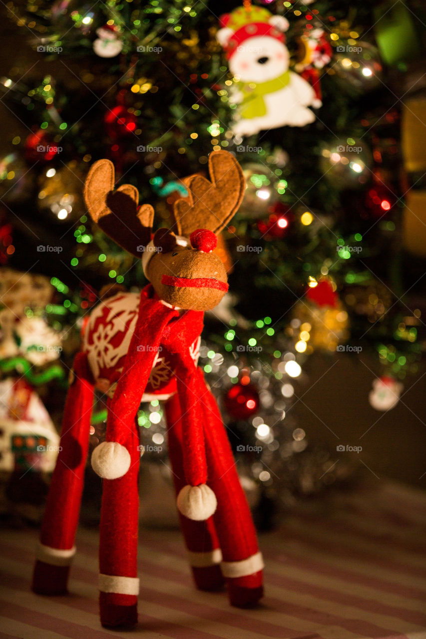 My favourite Christmas decoration - a little Christmas reindeer on a table with gifts and a Christmas tree.