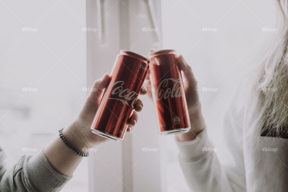 coca cola in hands / cheers with coca cola