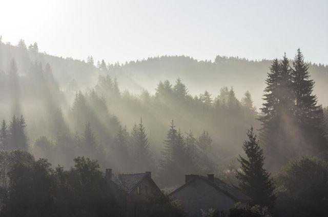 Sunbeams over the mountain and village