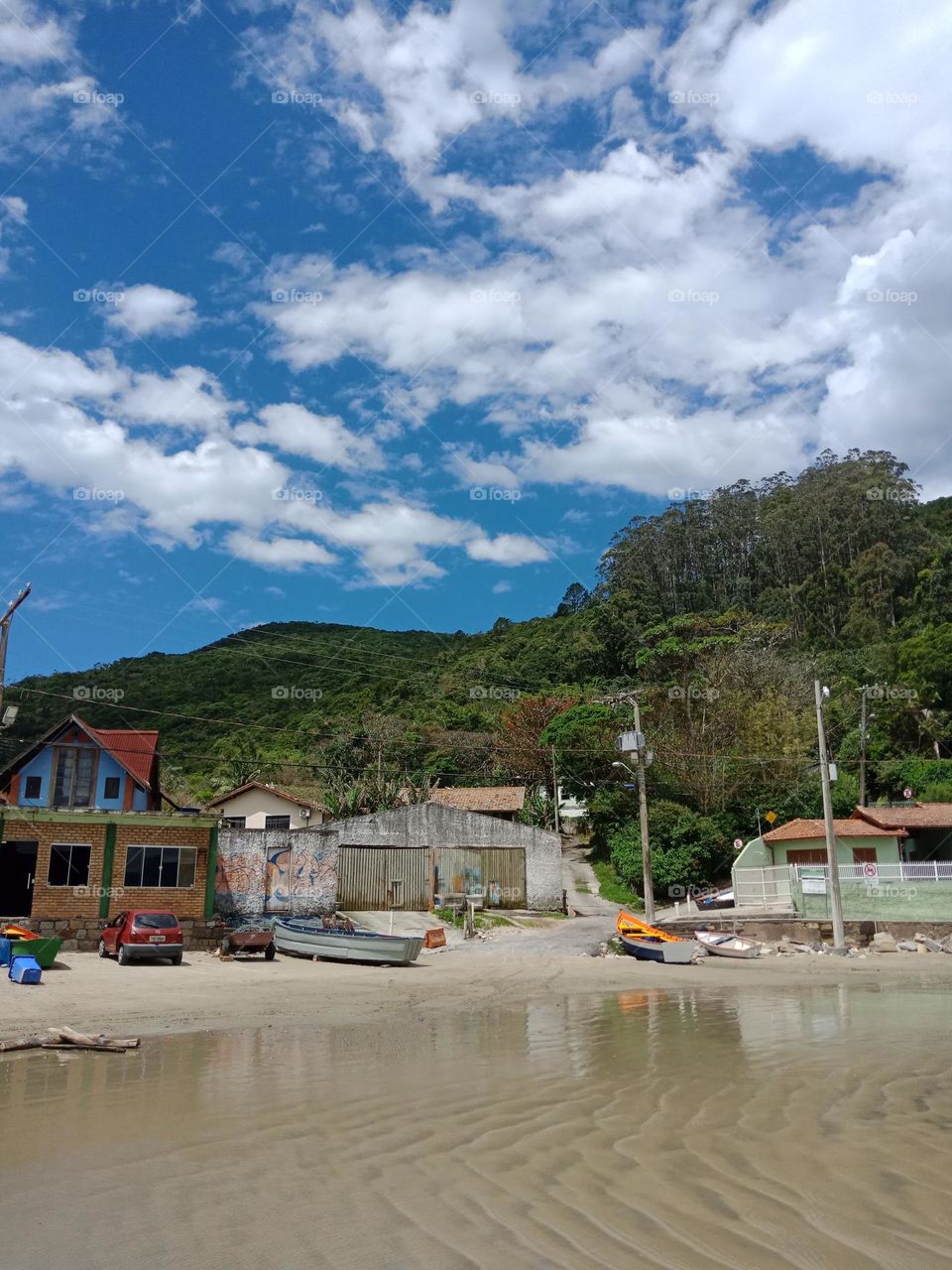 Fishermen village,  Pantano do Sul beach Florianópolis. Houses,  boats, mountains,  blue sky