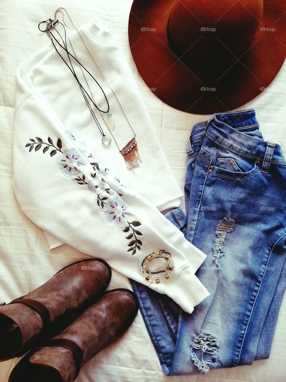 flat lay clothes jeans shirt hat boots