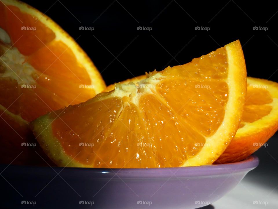 Orange on a lilac saucer