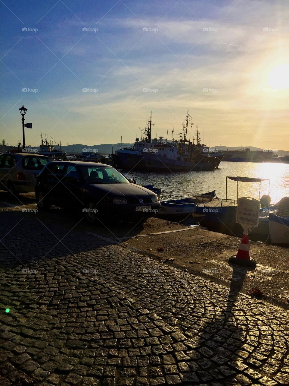 Мягкий бриз нежно колышет пришвартованные суда, а их контуры расплываются в синеве ночи , словно гигантские призраки , укрывающиеся под светом луны 