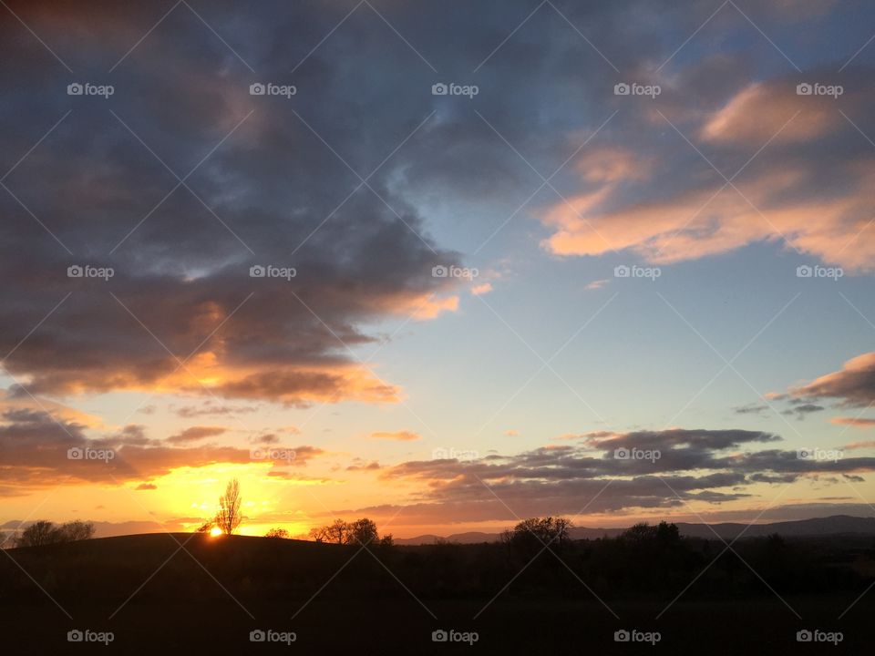 Dramatic sky with Malvern Hills and sunset in Worcestershire 