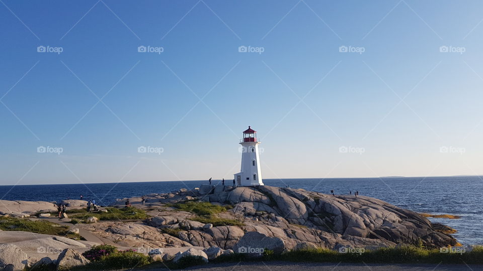 Lighthouse at Peggy's cove in sunset. Novia-Scotia, Canada.