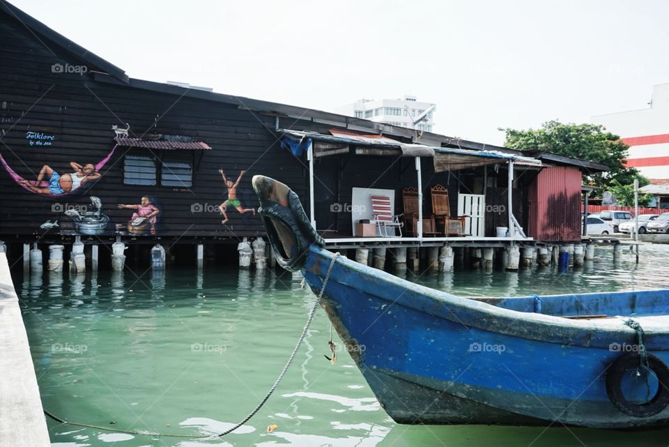 This is taken from Chew Jetty in Penang, Malaysia, which is named after a chinese clan. This water village is over a century old, and is under UNESCO world heritage.