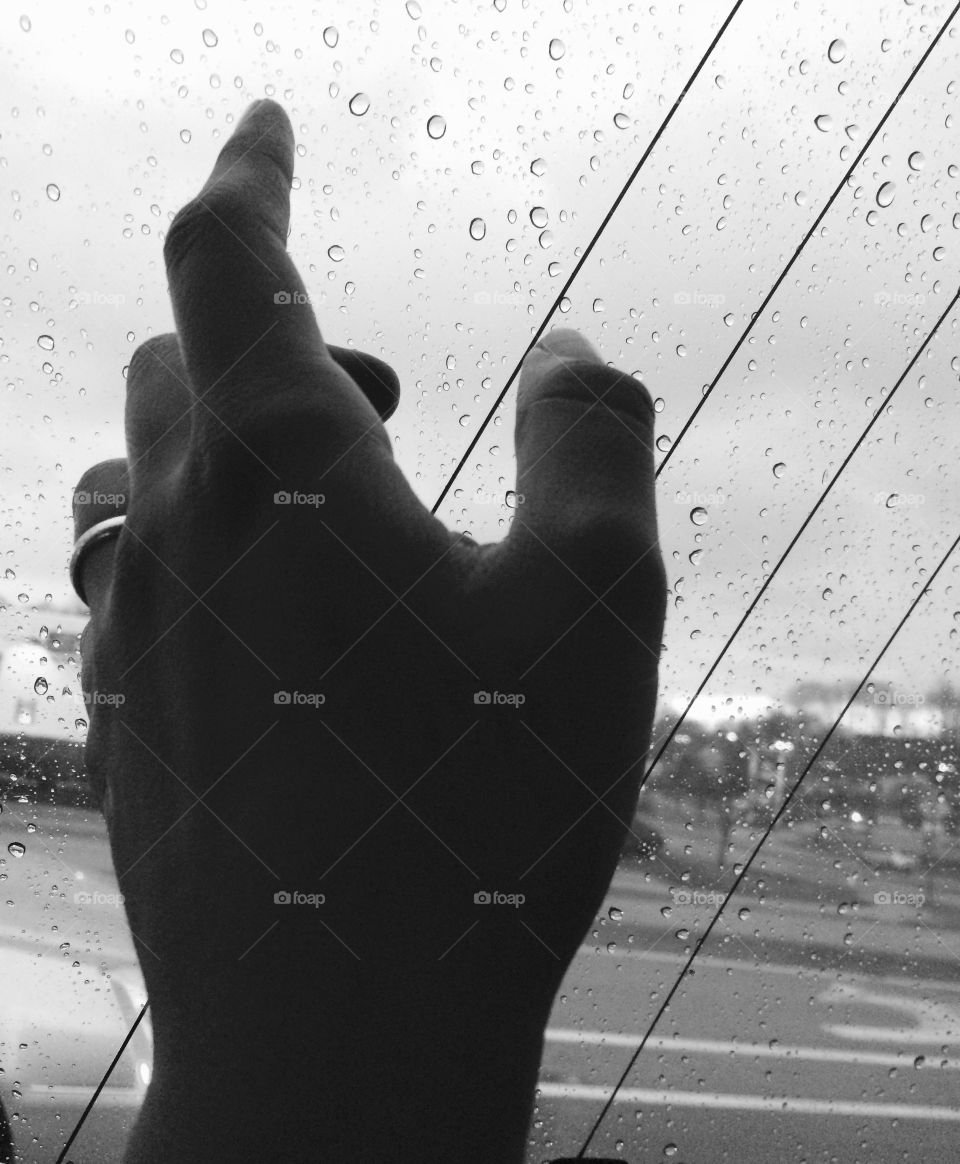 Black and white hand on window 