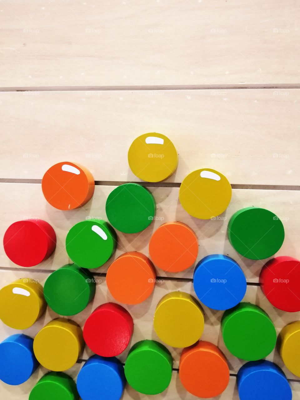 Colorful circles that were attached on wood.