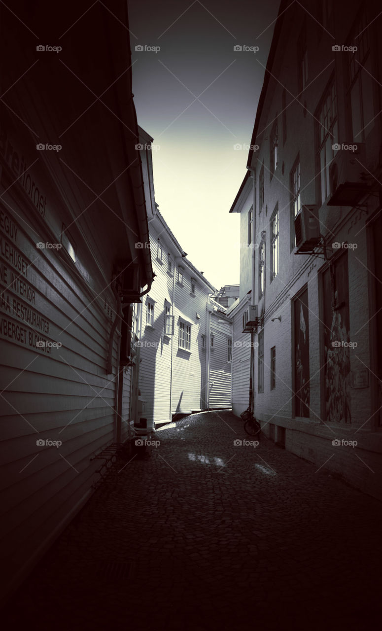 Black and white street photo. Taken in Stavanger Norway. Showing shadows and light.  